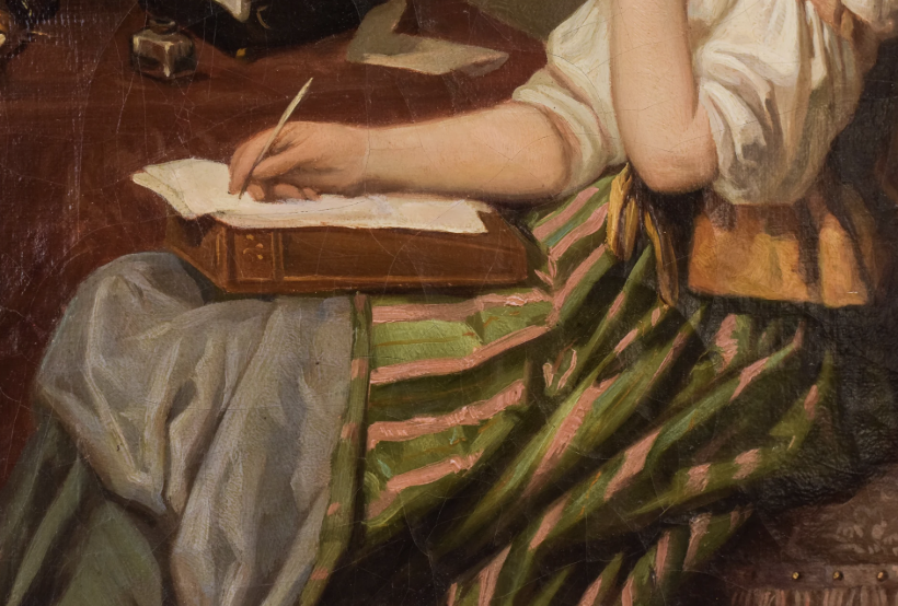 A woman writing by hand at a desk